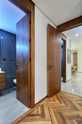 a pivot door in a bathroom with wood flooring at Modern Unit in Casa Finance City With Free Parking in Casablanca