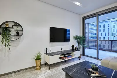 a living room with a flat screen tv on a wall at Modern Unit in Casa Finance City With Free Parking in Casablanca