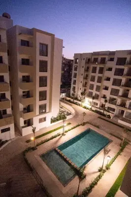 a swimming pool in front of two large buildings at Luxury apartment fully furnished in Casablanca