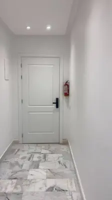 a room with a white door and a tile floor at New Luxury apartment 5 min Casablanca Mohammed V Airport in Casablanca