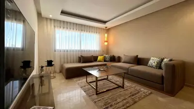 a living room with a couch and a table at The building of Terrazas 34 - By AppartAli in Casablanca