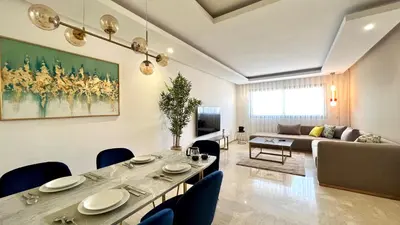 a living room with a table and a couch at The building of Terrazas 34 - By AppartAli in Casablanca