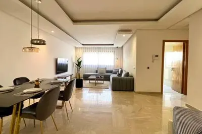 a living room with a table and chairs and a couch at Business Travelers and Families - 3 Bedrooms in Casablanca