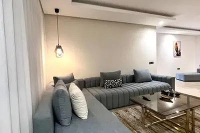 a living room with a couch and a table at Business Travelers and Families - 3 Bedrooms in Casablanca