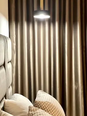 a bedroom with a silver curtain and a bed with pillows at La Vida est Magnifique - 3 Chambres in Casablanca
