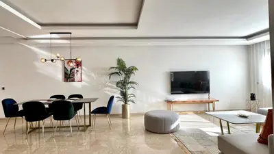 a living room with a dining room table and chairs at La Vida est Magnifique - 3 Chambres in Casablanca