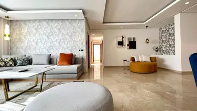 a living room with a couch and a table at La Vida est Magnifique - 3 Chambres in Casablanca