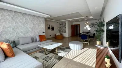 a living room with a couch and a table at La Vida est Magnifique - 3 Chambres in Casablanca