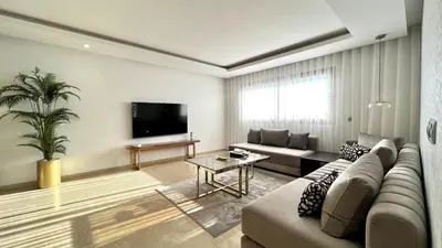a living room with a couch and a tv at Marvelous Center Spot - 3 Bedrooms in Casablanca