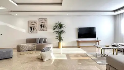 a living room with a couch and a tv at Marvelous Center Spot - 3 Bedrooms in Casablanca