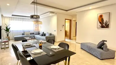 a living room with a dining table and a couch at Family 3 Bedrooms- By AppartAli in Casablanca