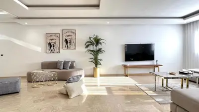 a living room with a couch and a tv at Family 3 Bedrooms- By AppartAli in Casablanca