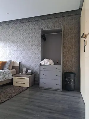 a bedroom with a bed and a dresser at Studio ALMASSIRA in Casablanca