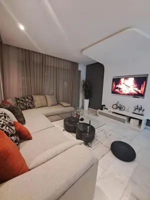 a living room with couches and a flat screen tv at Studio ALMASSIRA in Casablanca