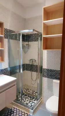 a bathroom with a shower and a toilet at Appartement Perla - Costa Bouznika in Bouznika