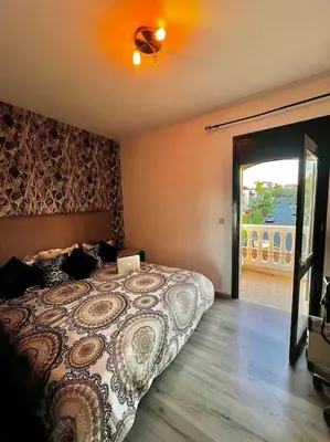 a bedroom with a bed with a laptop on it at Nassali - Luxurious Beachfront Villa with Private Pool in Casablanca