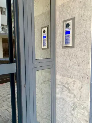 a door with two windows on the side of a building at Élégance en 40 mètres Nouaceur in Nouaceur