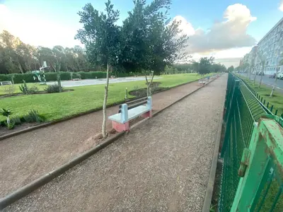 a park with benches on the side of a road at Élégance en 40 mètres Nouaceur in Nouaceur