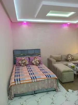 a bedroom with a bed and a couch at Studio Zenith in Casablanca