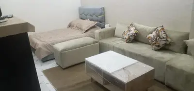 a living room with a couch and a bed at Studio Zenith in Casablanca
