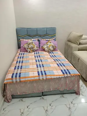 a bed with a blue headboard in a room at Studio Zenith in Casablanca