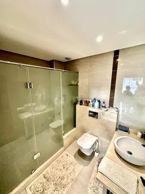 a bathroom with a shower and a toilet and a sink at Oasis de Sérénité en Bord de Mer in Casablanca