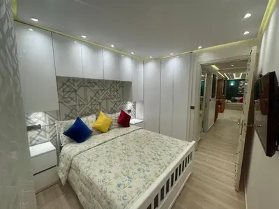 a bedroom with a large bed with colorful pillows at Appartement spacieux et moderne in Casablanca