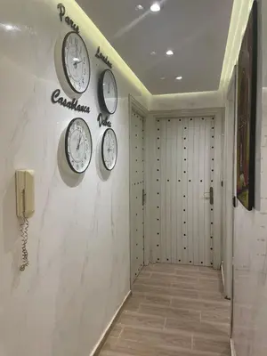 a hallway with four clocks on the wall at Appartement spacieux et moderne in Casablanca