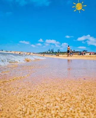 a group of people walking on a beach with a kite at Résidence Ryad Albahr Herhoura in Temara