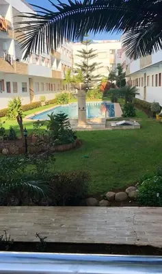 a view of a yard with a swimming pool at Résidence Ryad Albahr Herhoura in Temara