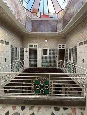 a large room with a ceiling with a stained glass window at Riad Blue Garden in Rabat