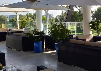 a restaurant with tables and chairs and an umbrella at Bahia Golf Beach Bouznika appart in Bouznika