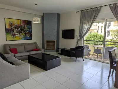 a living room with a couch and a table at Bahia Golf Beach Bouznika appart in Bouznika