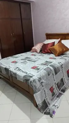 a bed with a comforter on it in a room at tranquil harmony in Casablanca