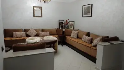 a living room with a brown couch and a table at tranquil harmony in Casablanca