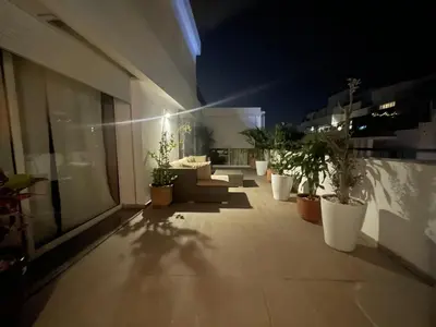 a patio with potted plants on a building at night at Central, terrasse, confortable - Bleue résidence in Casablanca