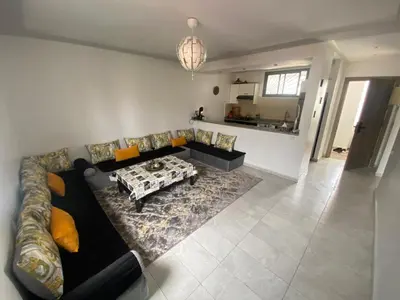 a living room with a couch and a table at Marbella beach appart de standing in Mansouria