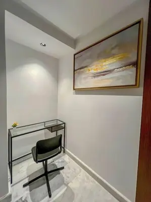 a chair in a room with a painting on the wall at Studio Haven in the Old Medina in Casablanca
