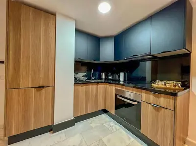 a kitchen with wooden cabinets and a stove top oven at Studio Haven in the Old Medina in Casablanca