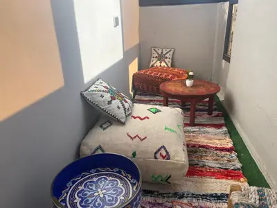 a living room with a couch and a table at Dar MAKTOUBE in Mohammedia