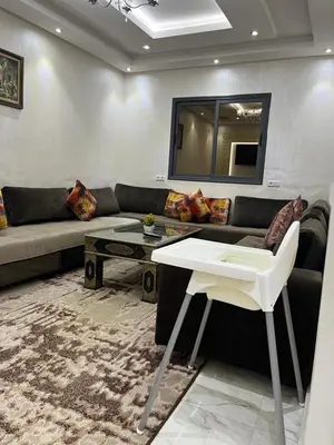 a living room with a couch and a table at Dar MAKTOUBE in Mohammedia