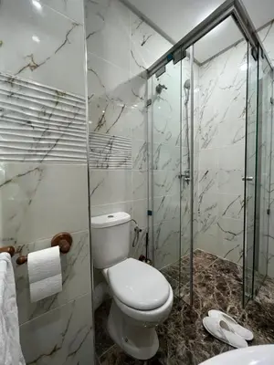 a bathroom with a toilet and a glass shower at Dar MAKTOUBE in Mohammedia