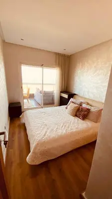 a bedroom with a large bed with a large window at Bel appartement pieds sur mer in Casablanca