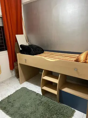 a black cat laying on a bunk bed at Apparemment TAMARIS in Dar Bouazza