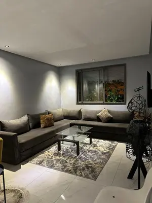 a living room with a couch and a table at Appartement propre 2 Chambres in Casablanca