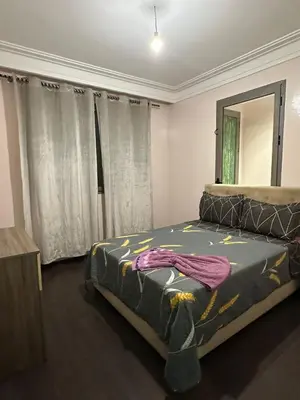 a bedroom with a bed and a mirror at Appartement propre 2 Chambres in Casablanca