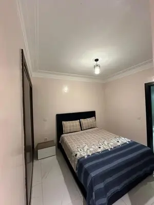 a bedroom with a bed in a white room at Appartement propre 2 Chambres in Casablanca