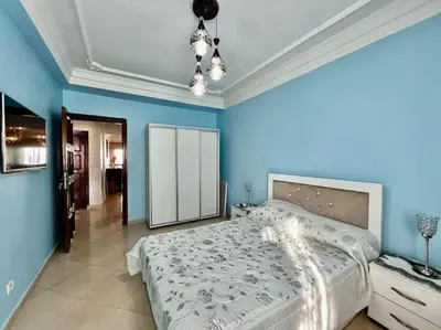 a bedroom with a large bed and blue walls at CASA Ghandi Central Apart 1Ch salon in Casablanca