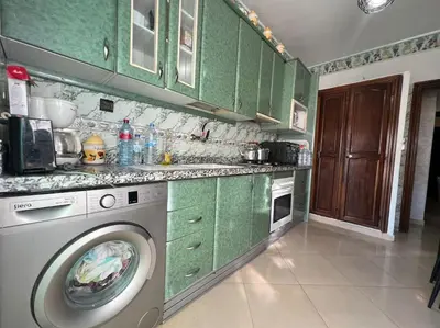 a kitchen with a washing machine and green cabinets at CASA Ghandi Central Apart 1Ch salon in Casablanca
