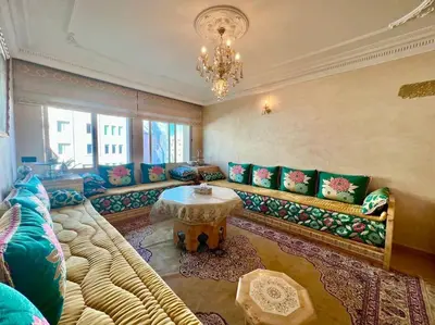 a living room with a large couch and a table at CASA Ghandi Central Apart 1Ch salon in Casablanca